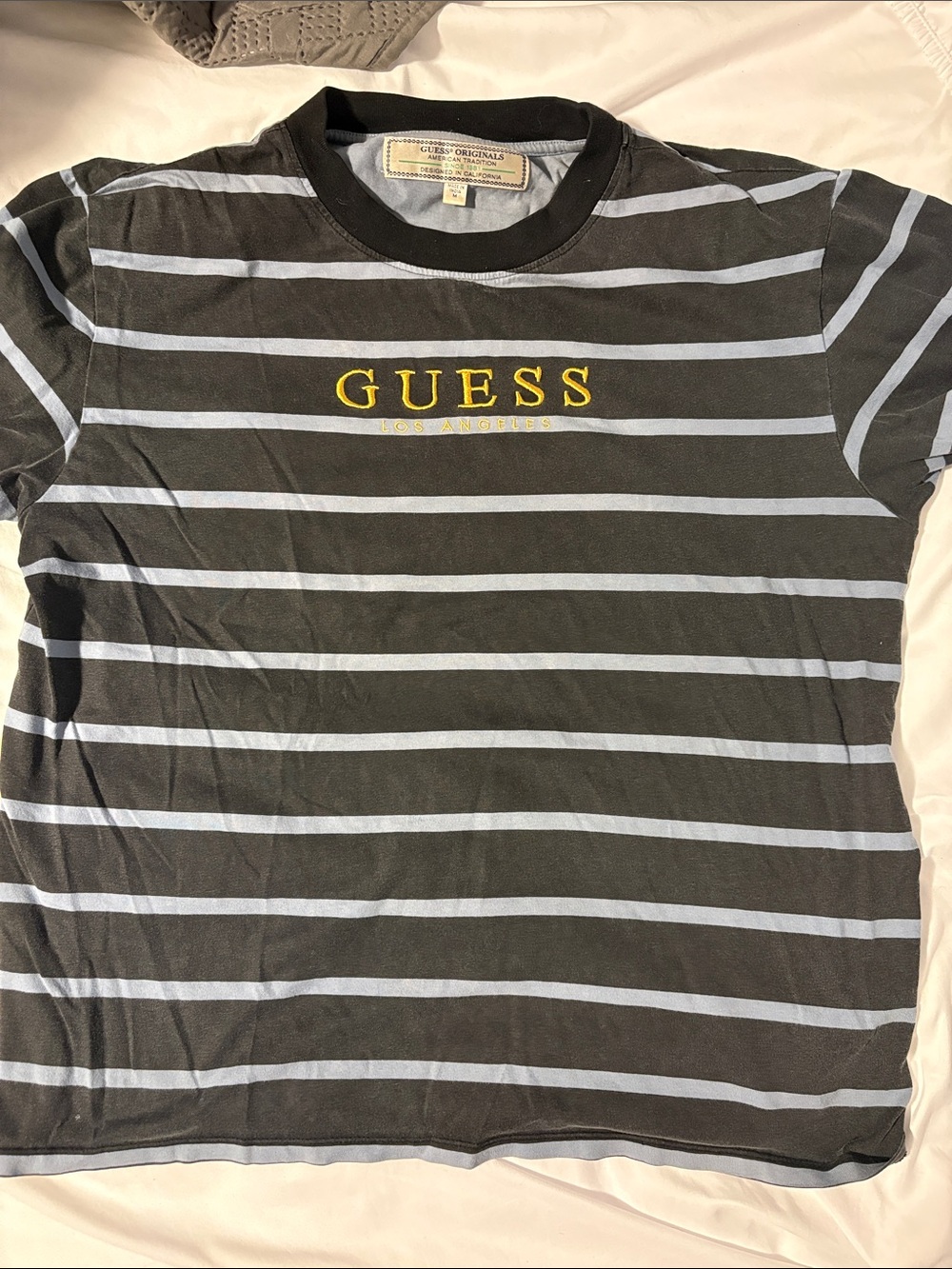 Guess Black Tee with Light Blue Stripes and Yellow Logo
